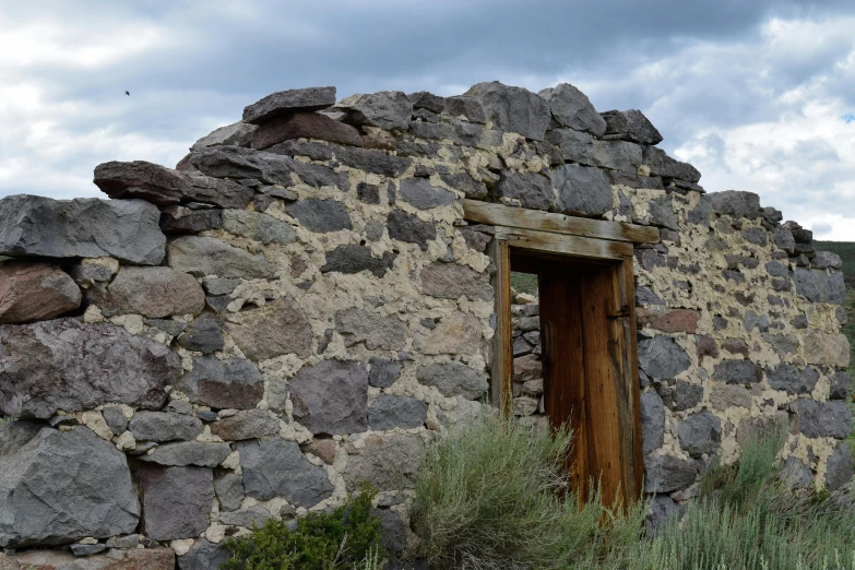 a small doorway in the side of an old stone building