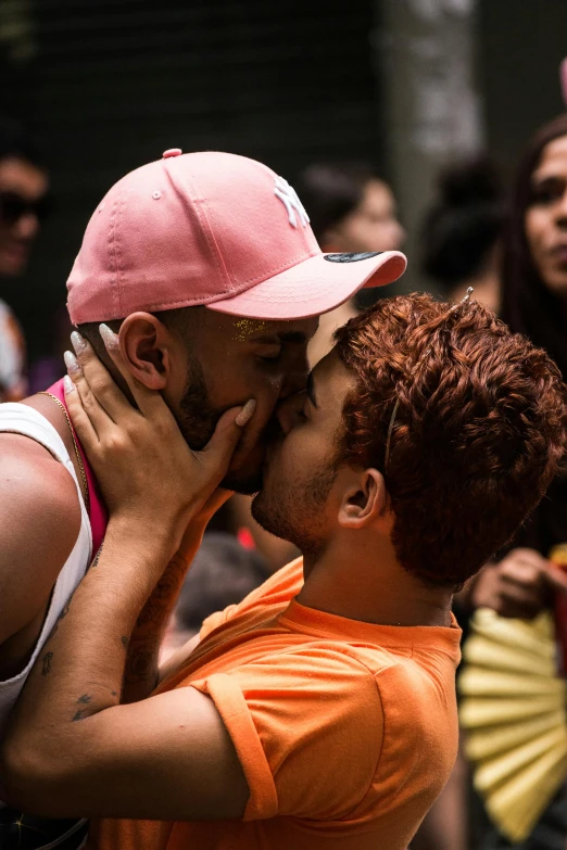 a person giving another person a kiss with the woman covering their eyes