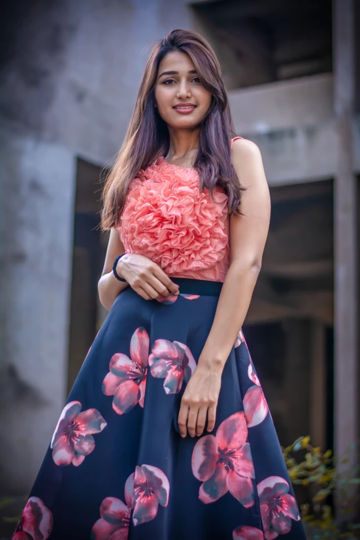 a woman wearing a dress and flower earrings