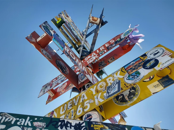 a large variety of signs attached to a pole