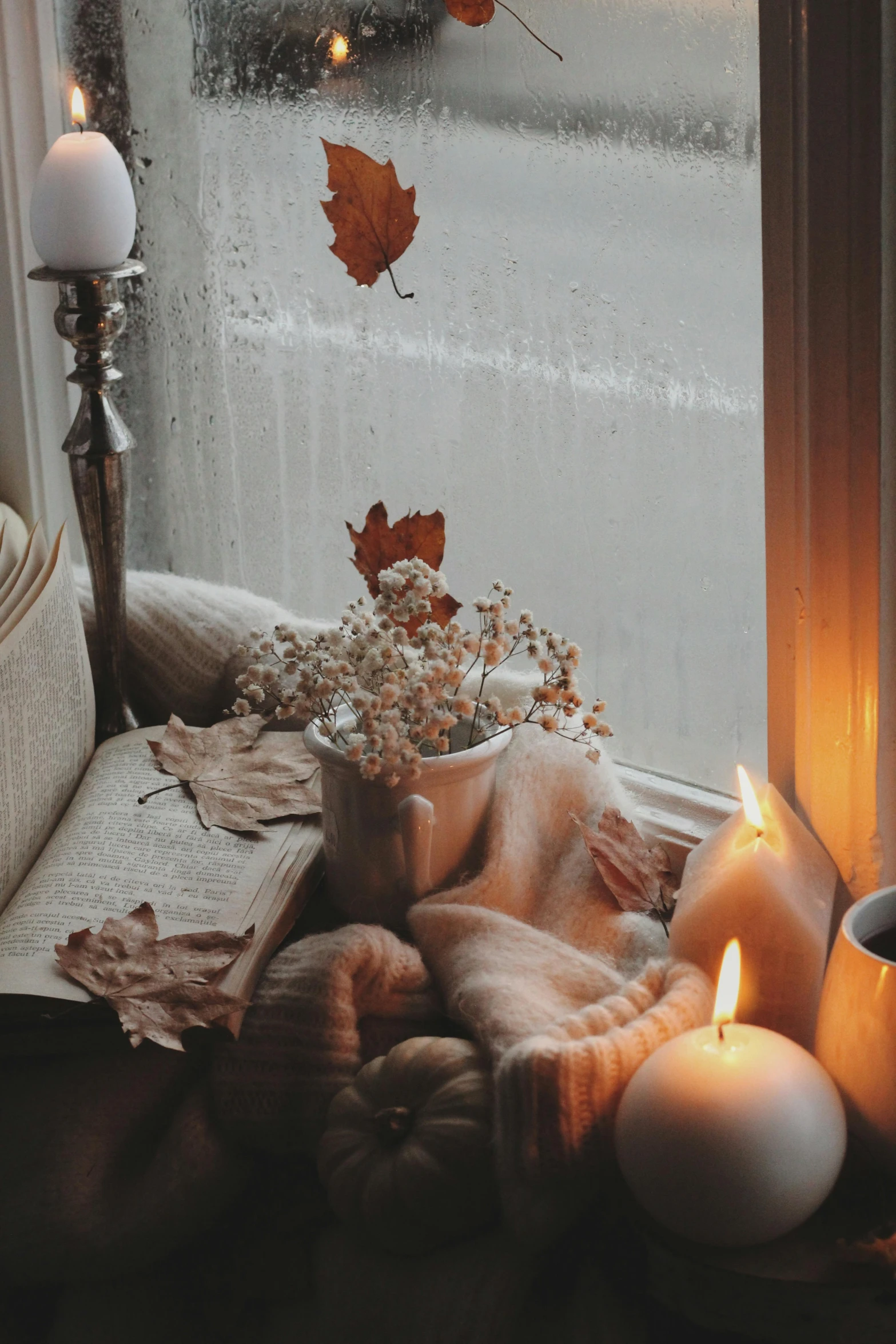 an open book on the floor by a window