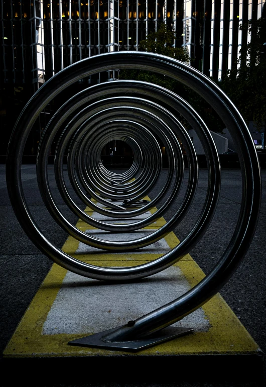 a pile of metal circles sitting on top of a cement ground