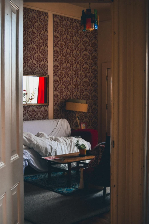 a person sits on a bed and has a desk in front of them