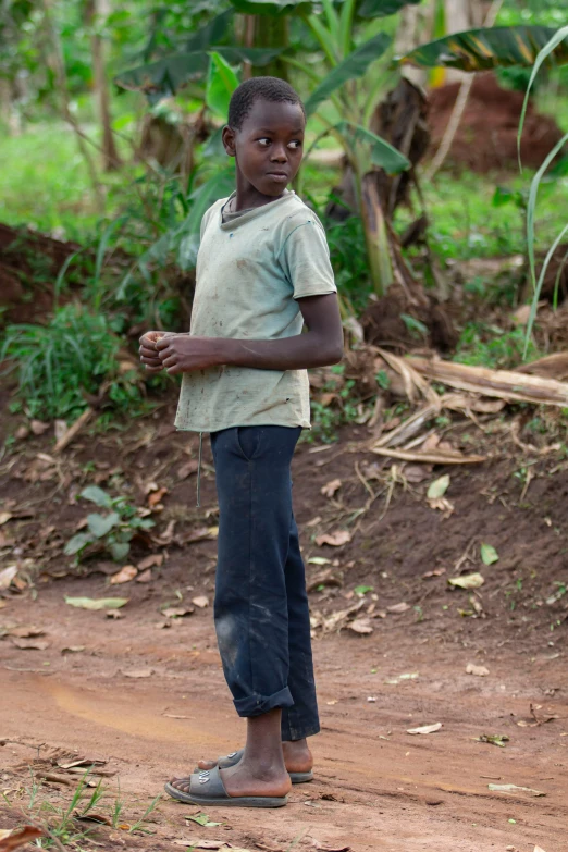 a young person is standing in the dirt