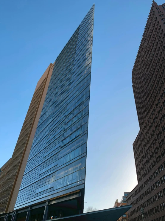 the facade of two modern buildings under a clear blue sky