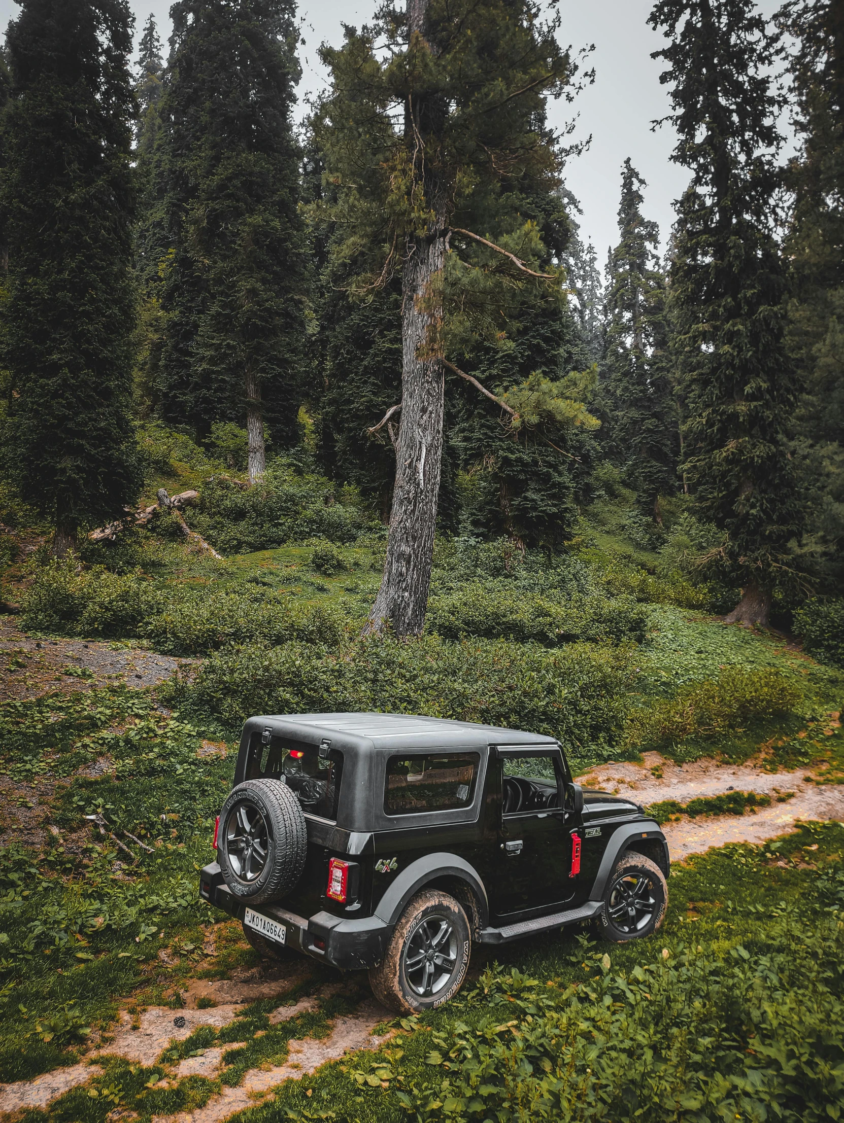 a jeep that is parked on a dirt road