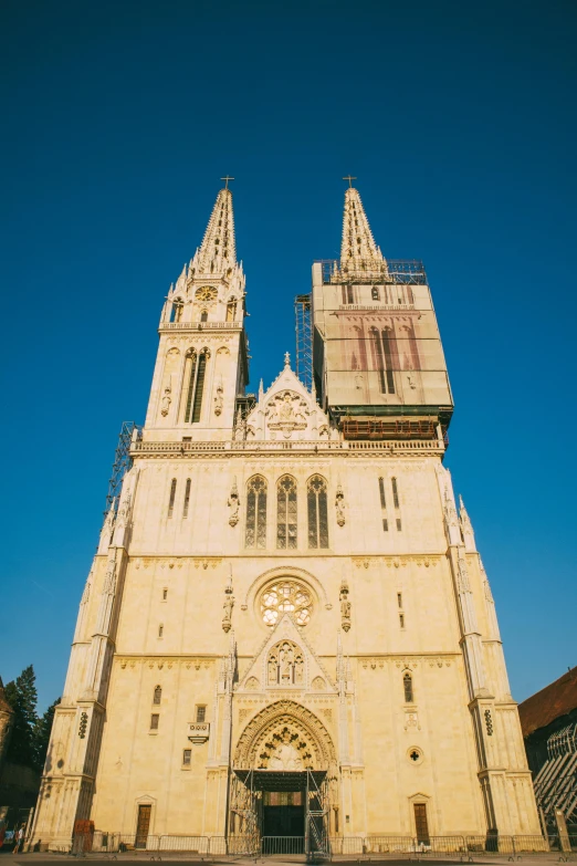 a very tall cathedral with three towers on the front