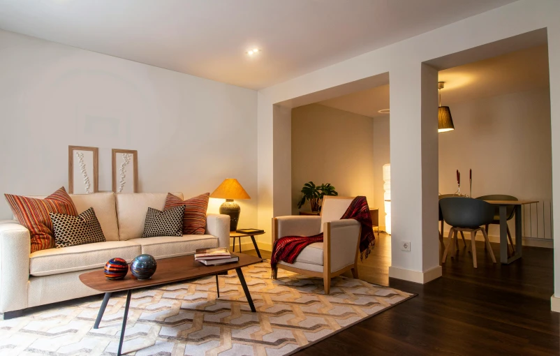 a living room area has a sofa and a coffee table with two lamps