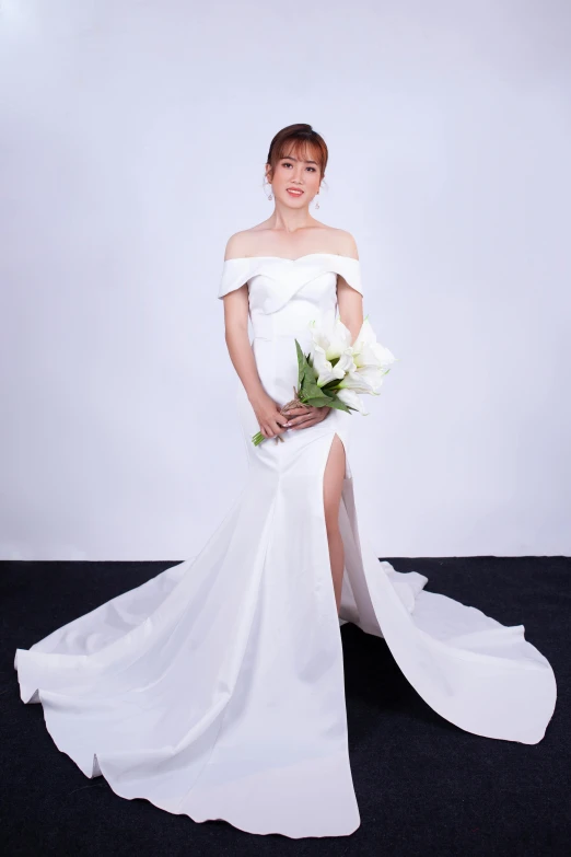 woman standing with bouquet in white dress