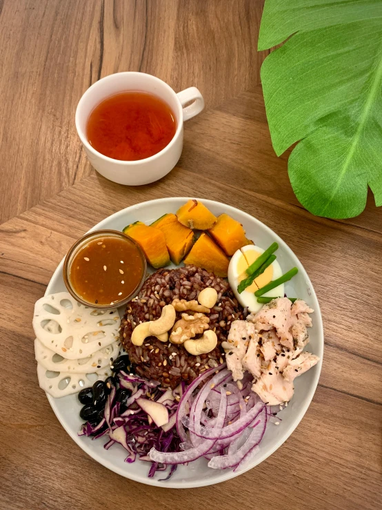 the plate is filled with meats, rice and fruit