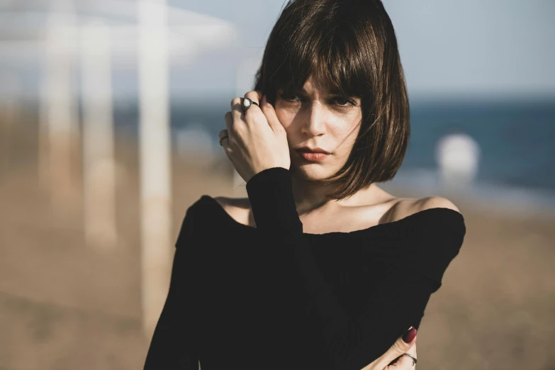 a woman posing for a po near a beach