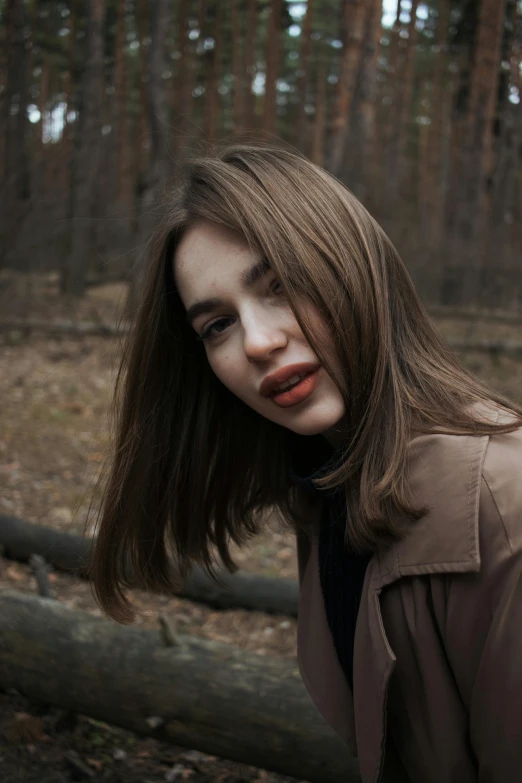 a woman that has brown hair and a jacket on