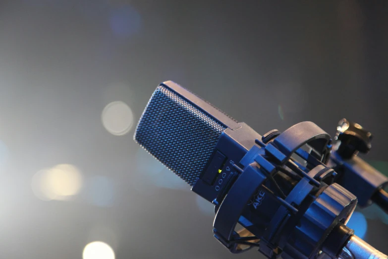 a blue microphone over a black background