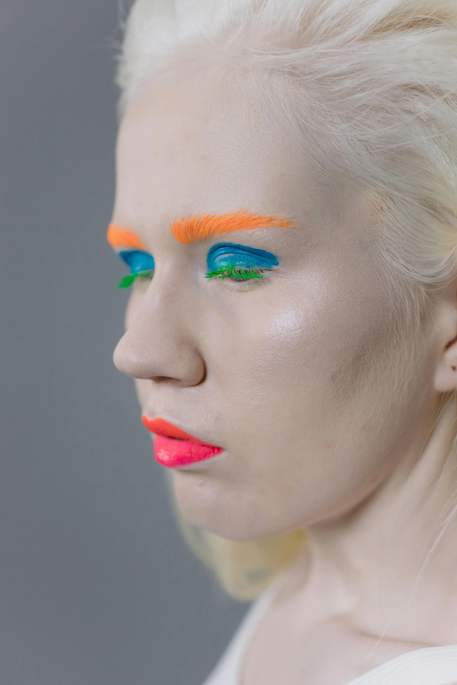 woman with white hair and colorful makeup