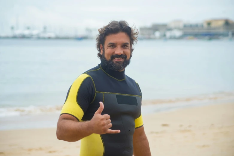 a man wearing a wet suit and thumbs up