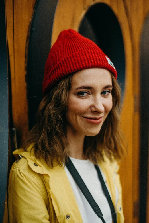 young lady smiling and wearing a red hat