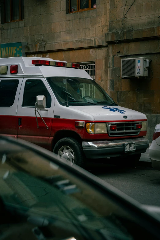 two ambulances parked in front of an old building