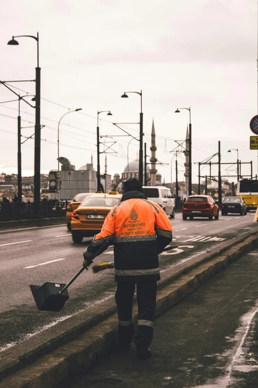 an asphalt worker shoveling the sidewalk and road