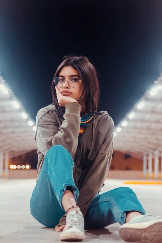 a woman is sitting in an underground tunnel and looks bored