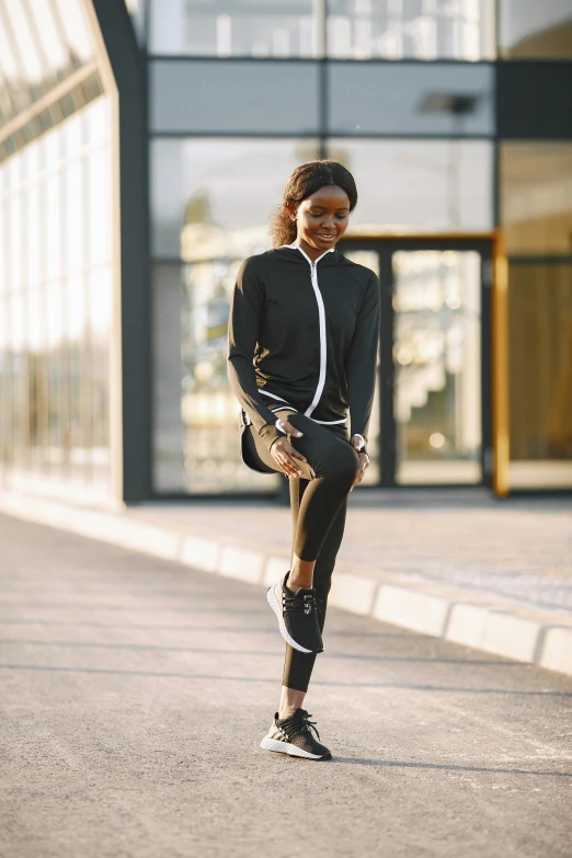 the woman is running outside in an open outfit