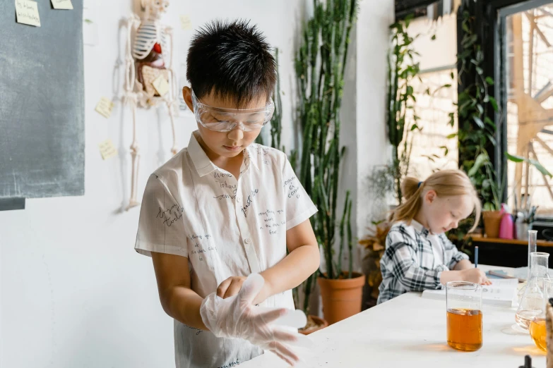 two children in lab gear are doing experiments