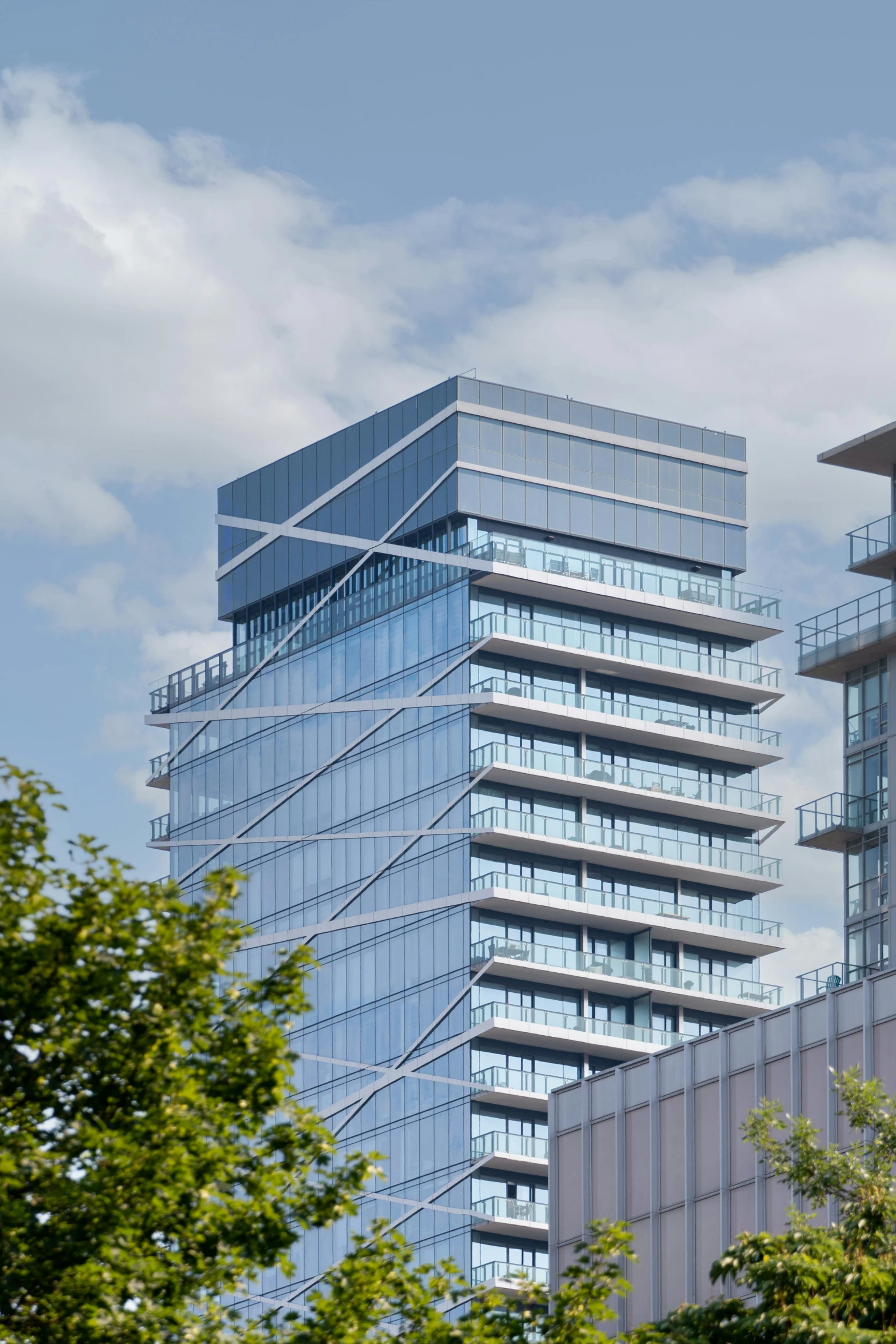 a building with many balconies and glass windows