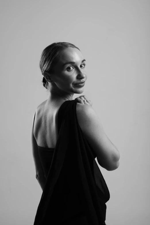 black and white image of woman in evening dress with hands under her sides