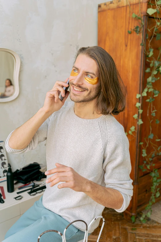 a man with yellow glasses talking on a cell phone