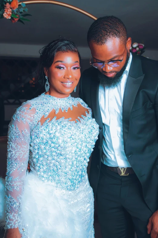 a man and woman in wedding clothes posing for a picture