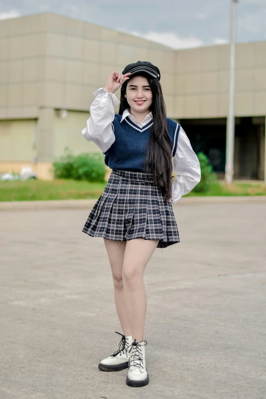 a girl standing on the street with her hands up to her ear