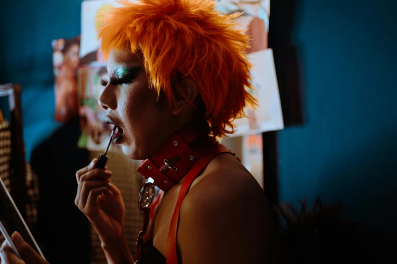 an punk chick with an orange wig smoking a cigarette