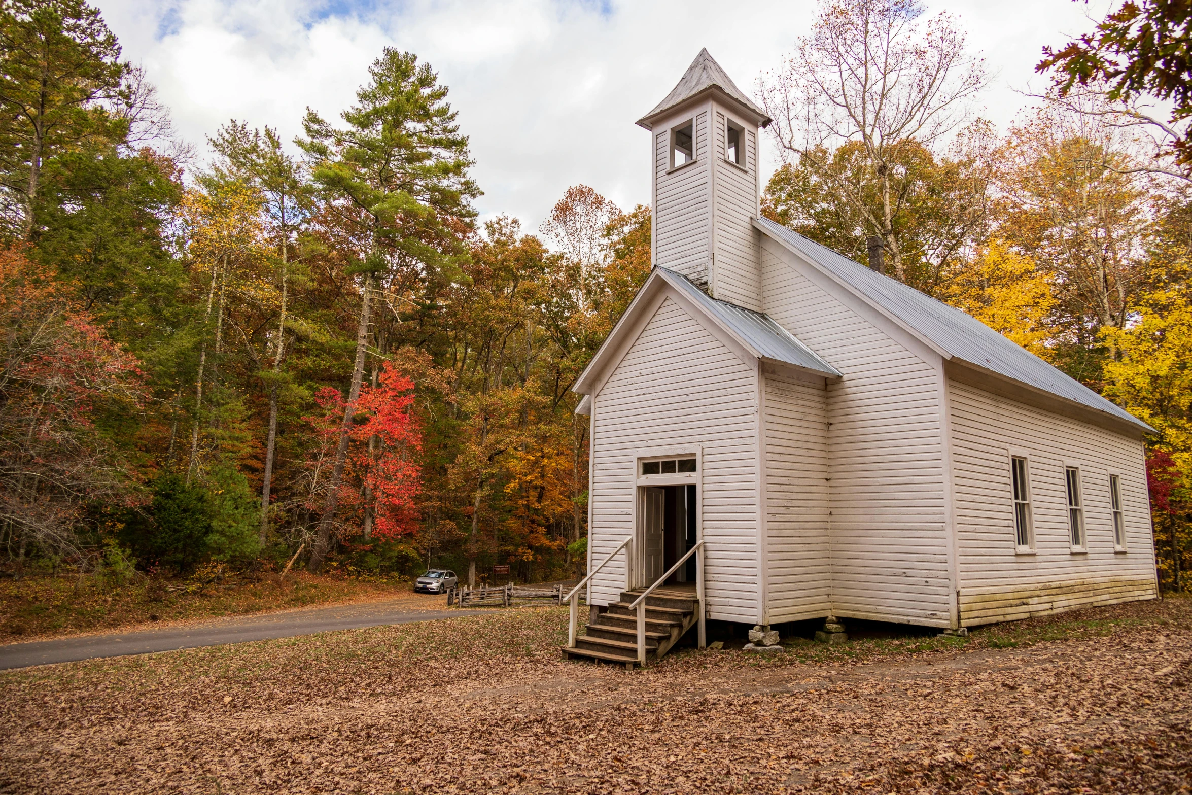 a small white building with a steeple and steeple