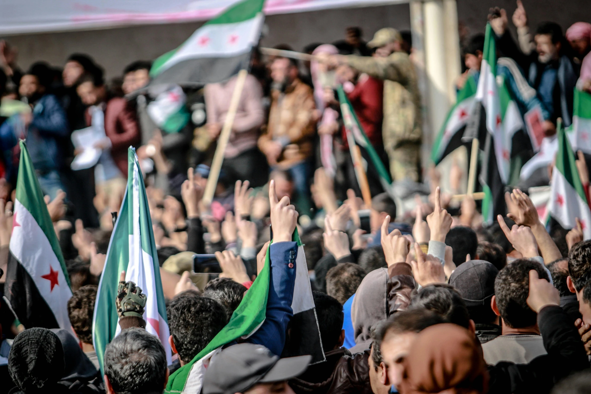 many people in the background are waving flags