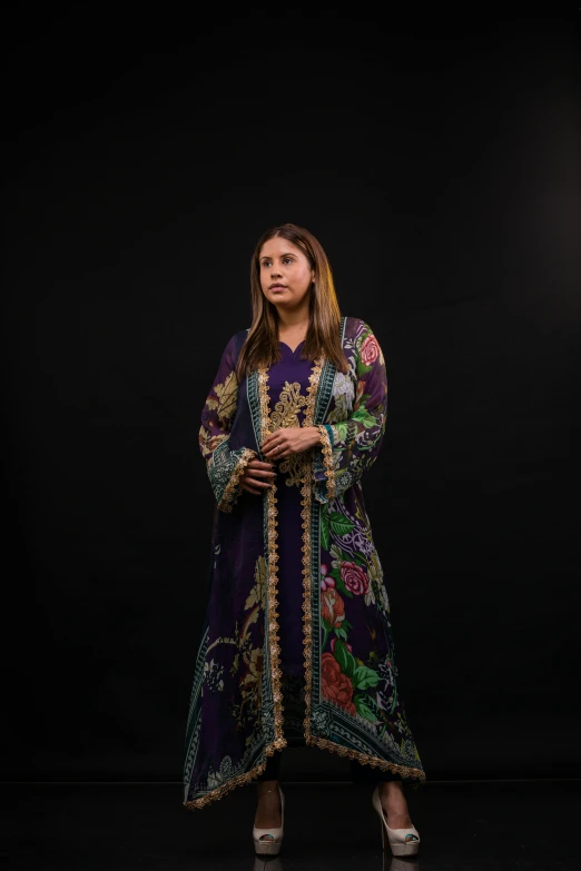 a woman standing with her arms folded and her legs crossed