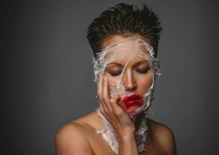 woman with fake makeup in the face and hands behind her head