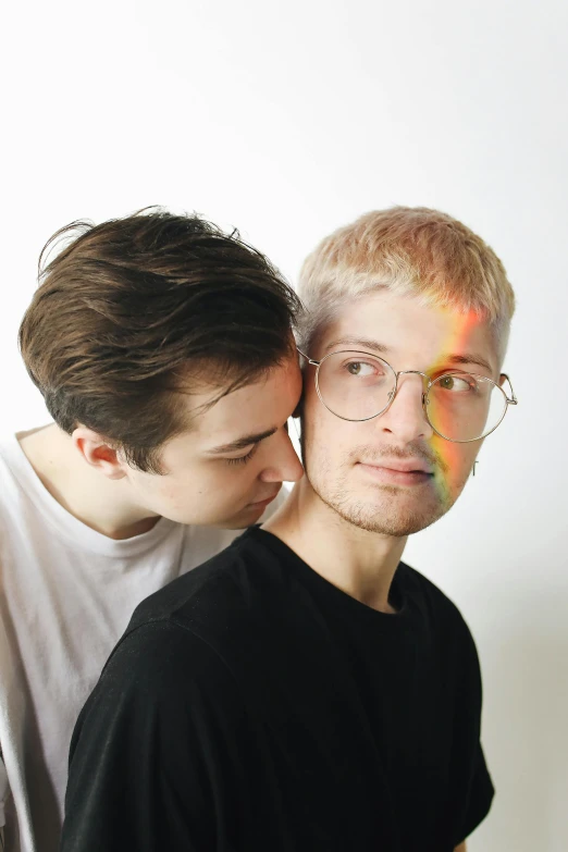two men with their faces partially covered by colored circles