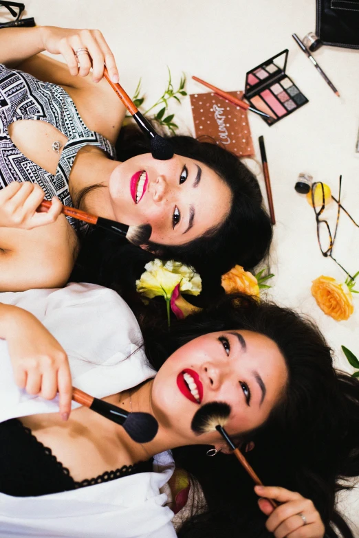 a group of young ladies laying on top of each other