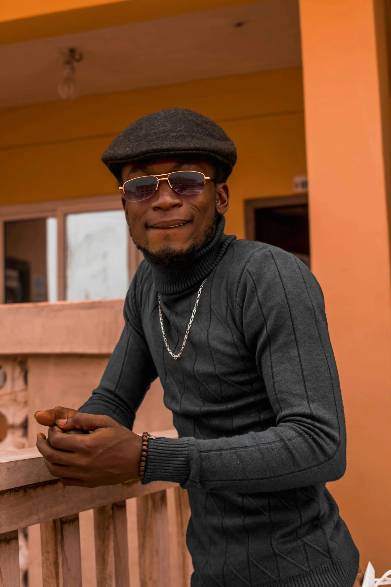 a man with a hat and sunglasses smiling