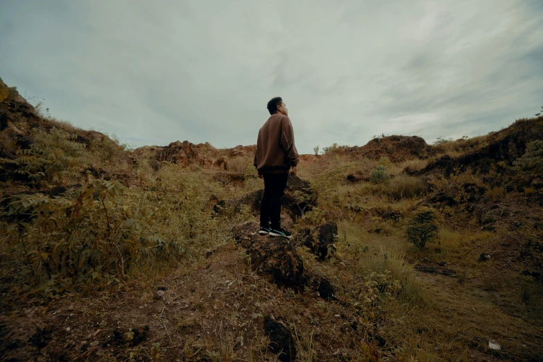 a man that is standing on top of a mountain