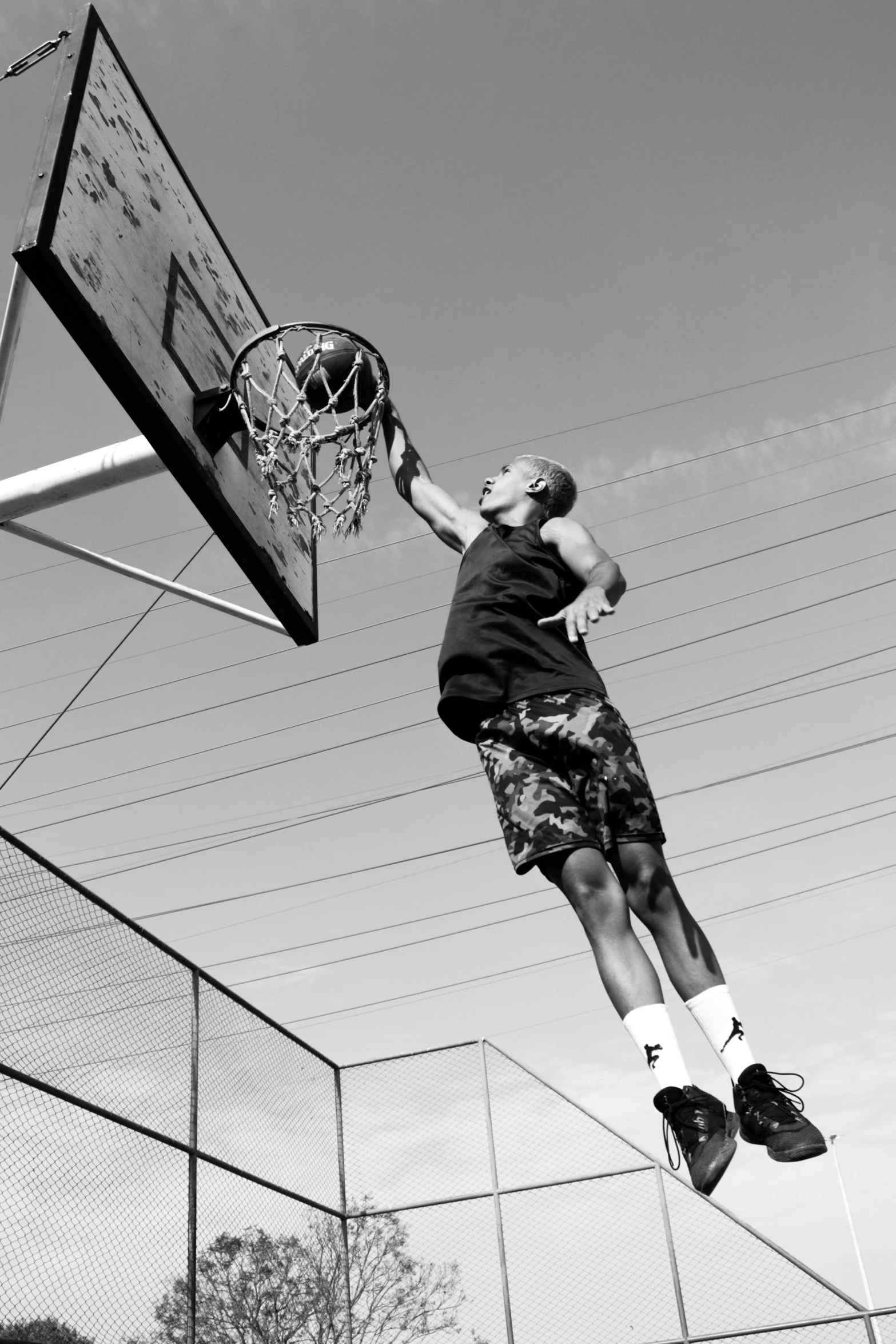 a person jumping up into the air near a basketball hoop