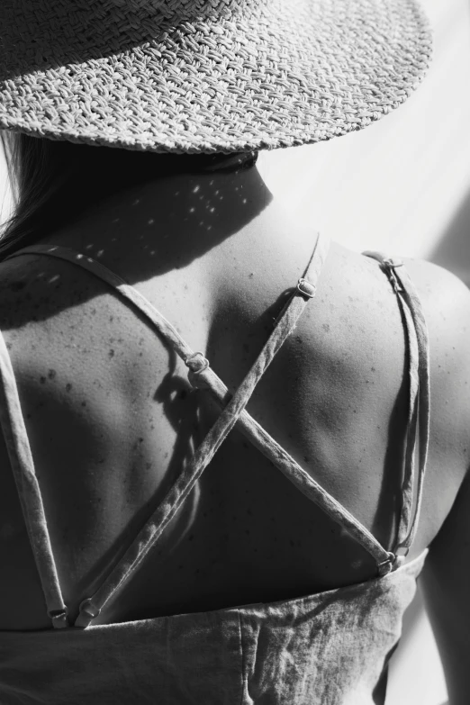 a woman in a straw hat looking up to the sky