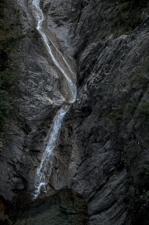 the waterfall is running up the side of a mountain