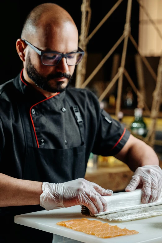 a chef puts food on top of some paper