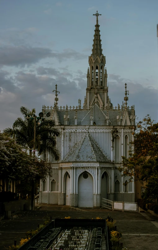 a church is surrounded by greenery and trees