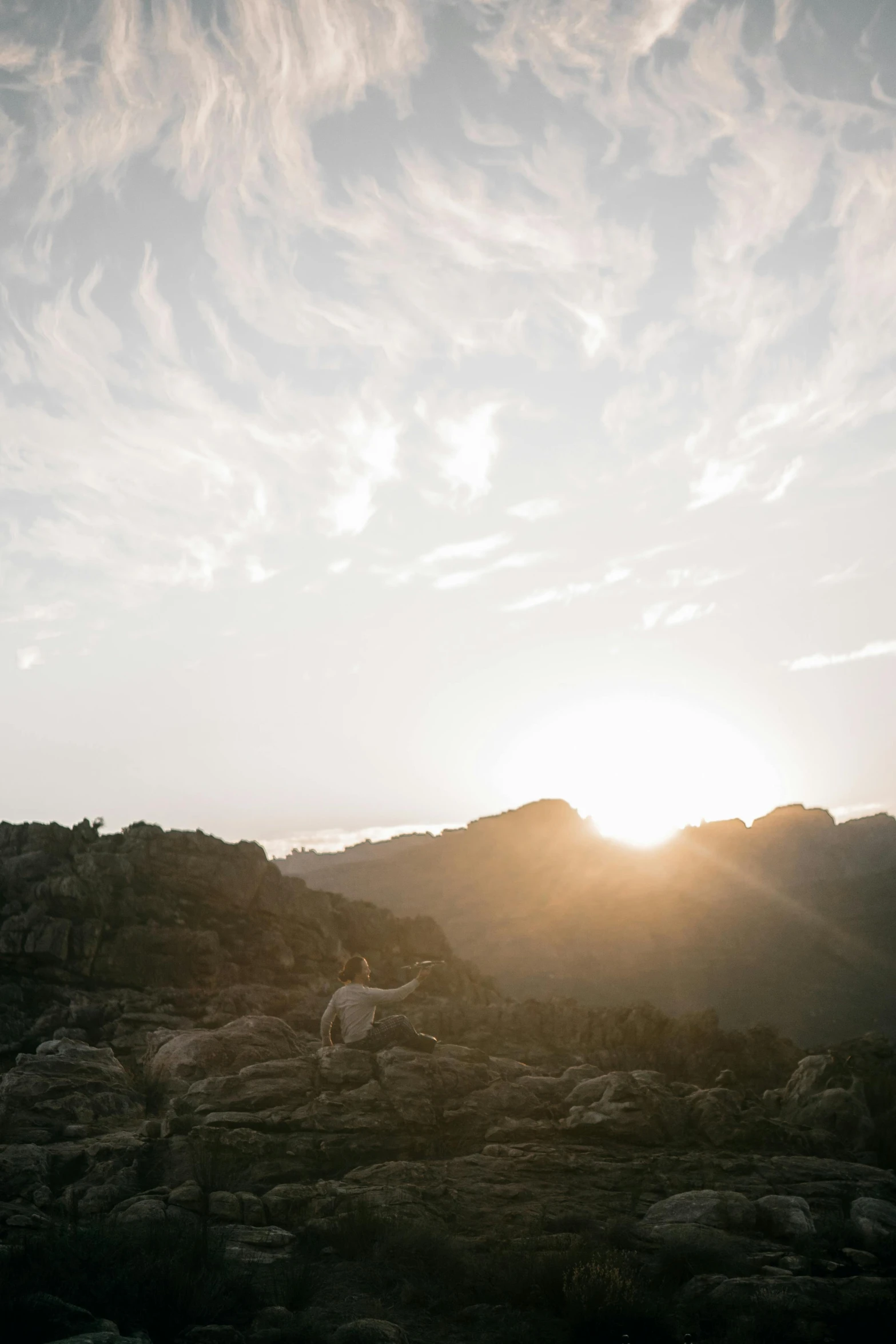 a po with rocks and clouds in the background