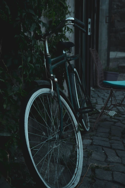 a bicycle is leaning against a building in the dark