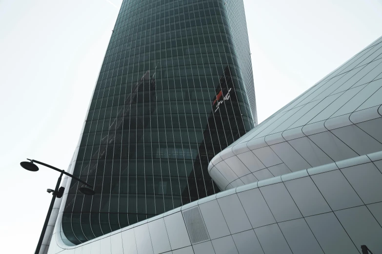 a tall office building next to a street light