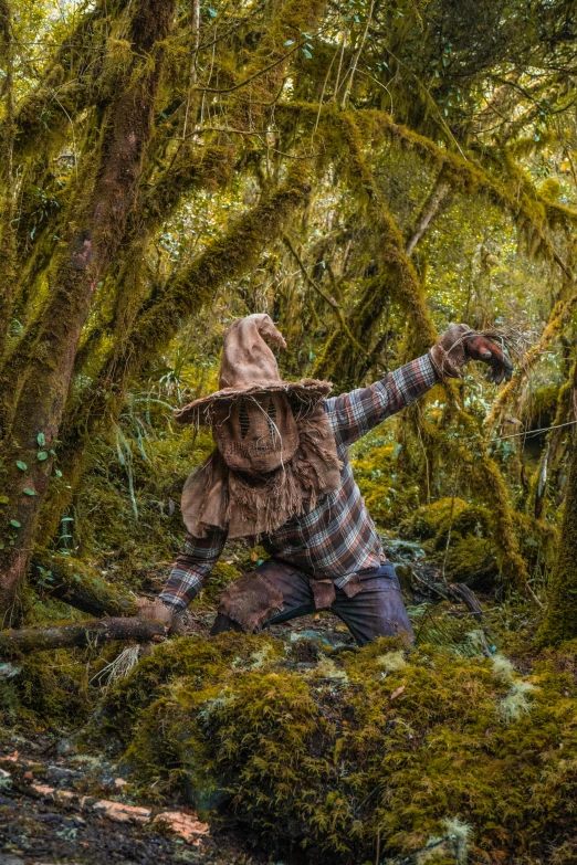 there is a person standing in the forest, holding out their arm