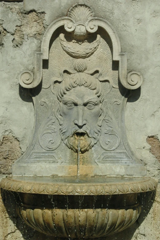 a fountain has a head on the top