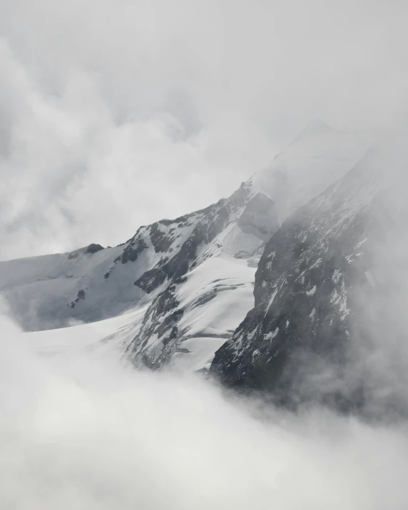 a ski slope in the mountains covered by low clouds